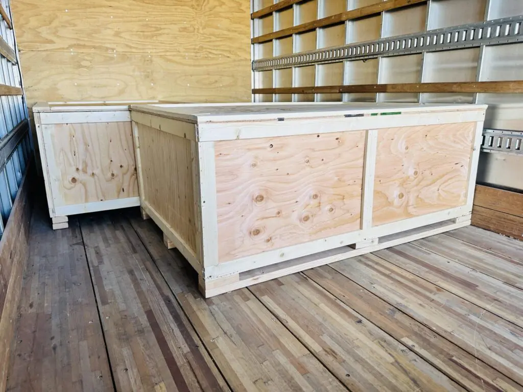 Custom wooden crates in a truck, showcasing tailored design for optimal protection and stability during shipping.