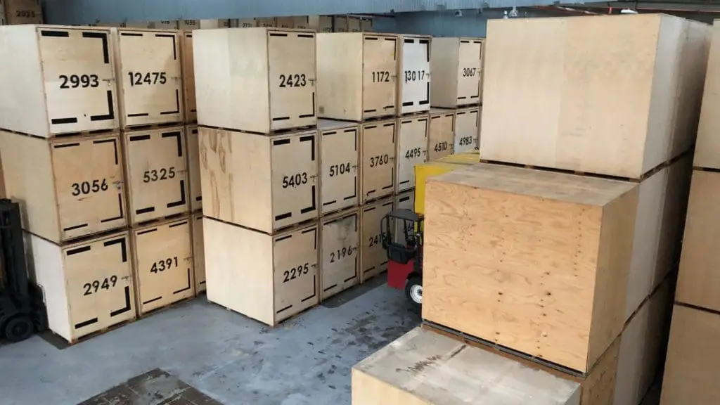 Custom wood crates stacked and forklift in warehouse for Crates of Las Vegas.