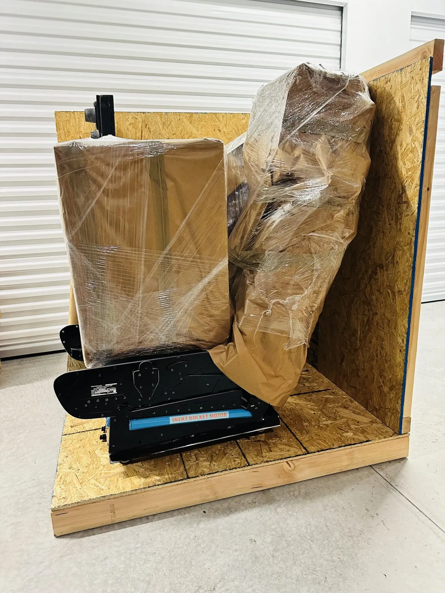 Wrapped items on a wooden crate base with upright panels behind them