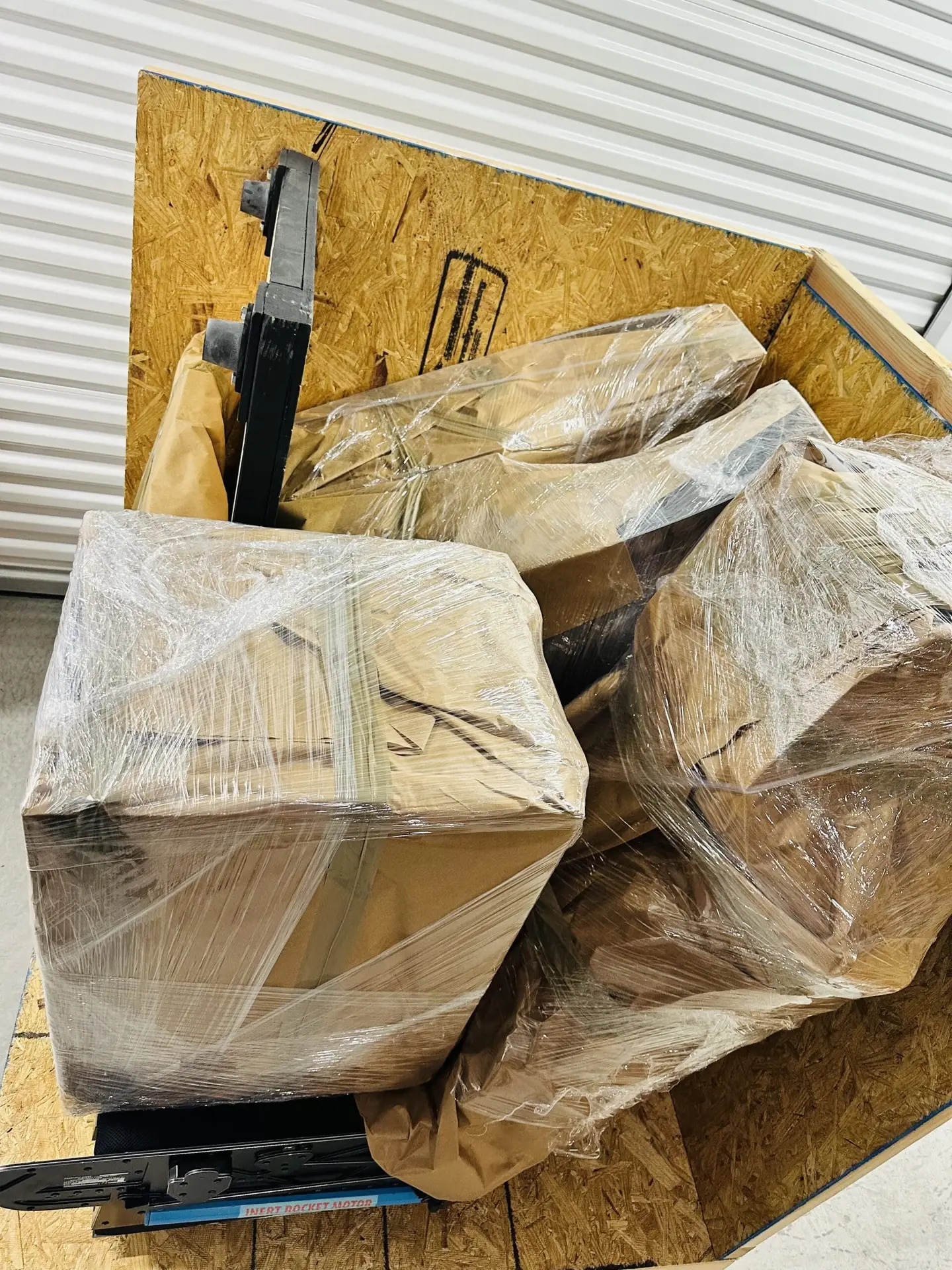Wrapped items held against a wooden packing frame.