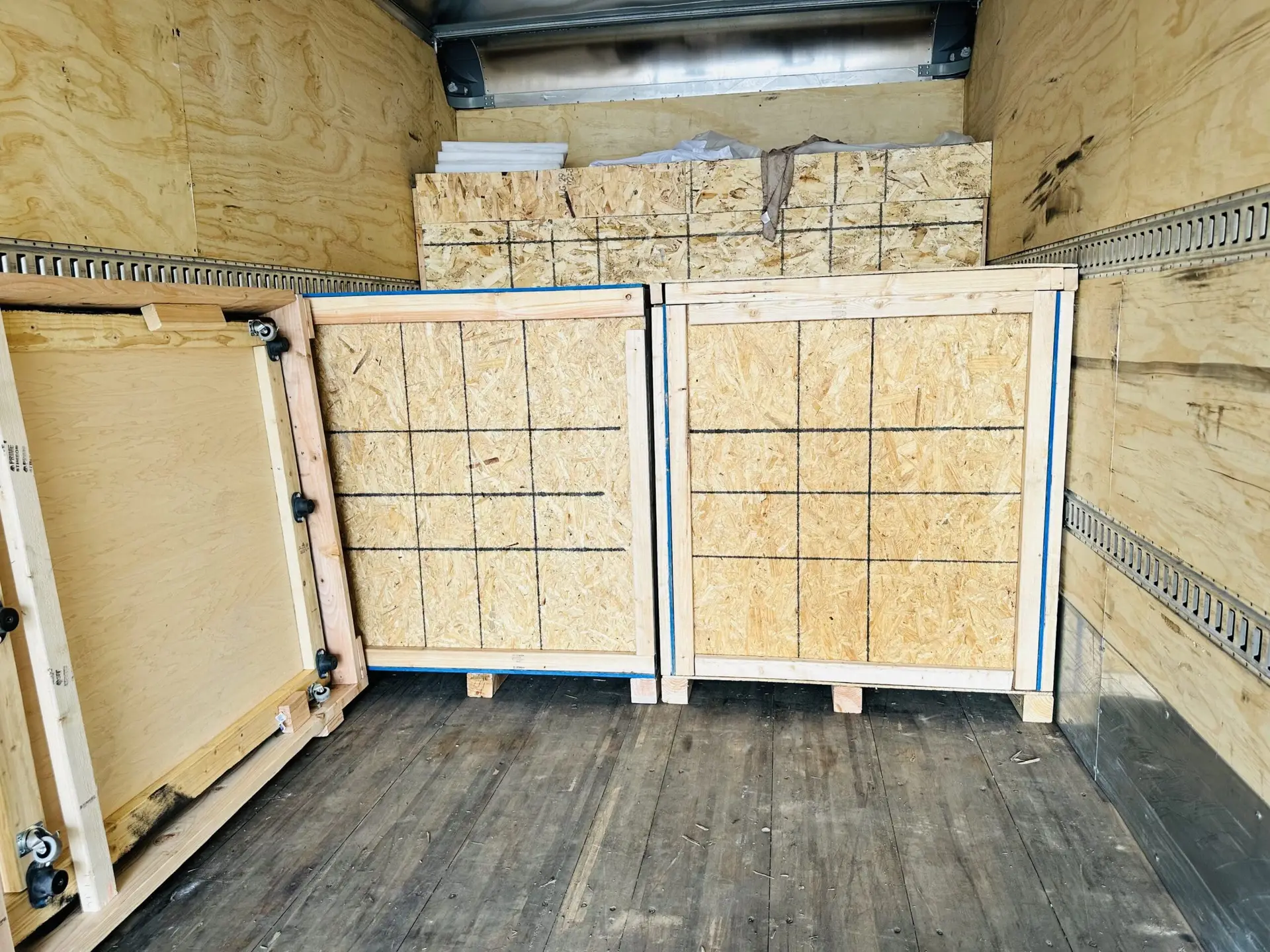 Wooden crates and panels inside a freight truck.