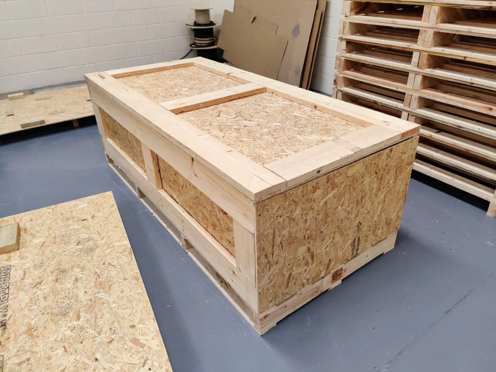 Rectangular wood-panel crate with a closed lid and timber framing.