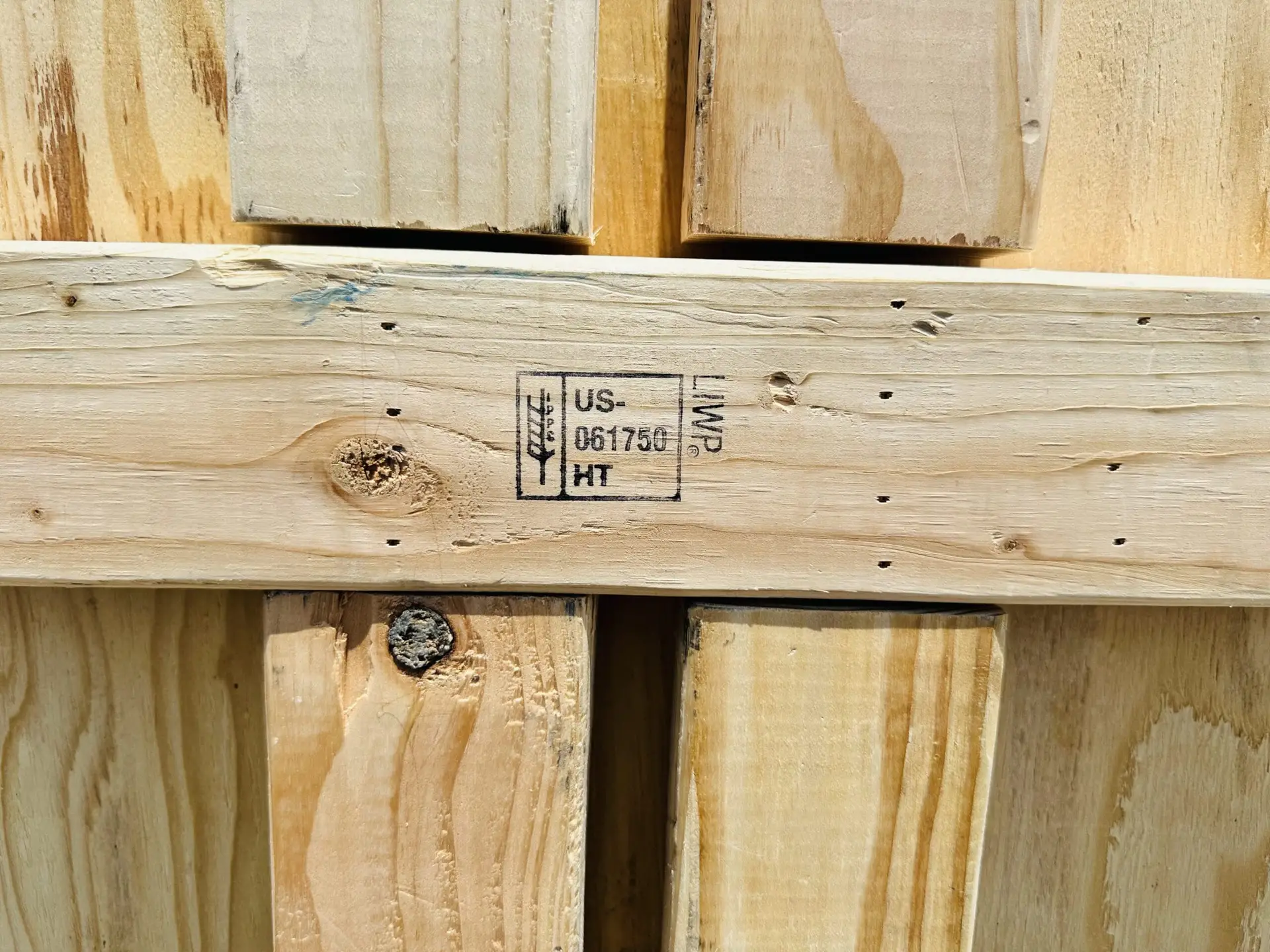 Close-up of a wood-packaging treatment mark on a crate crosspiece.