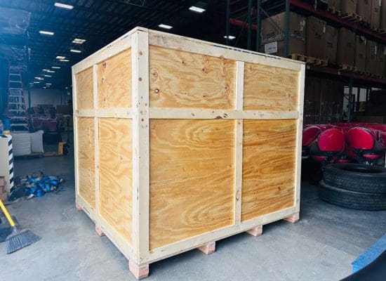 Wooden packing crate in a warehouse setting, emphasizing secure storage solutions for safe relocation services.