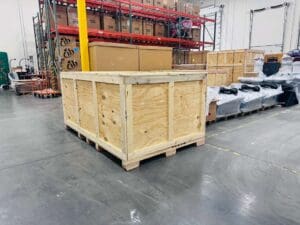 Custom wooden crate on a pallet in a warehouse, showcasing durable packaging solutions for shipping and storage at Crates of Las Vegas.
