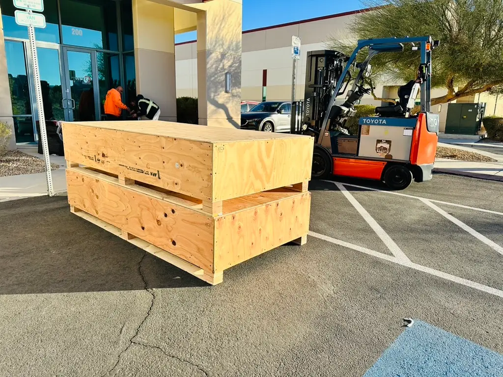 Custom wooden crate being forklifted, Crates of Las Vegas shipping services.