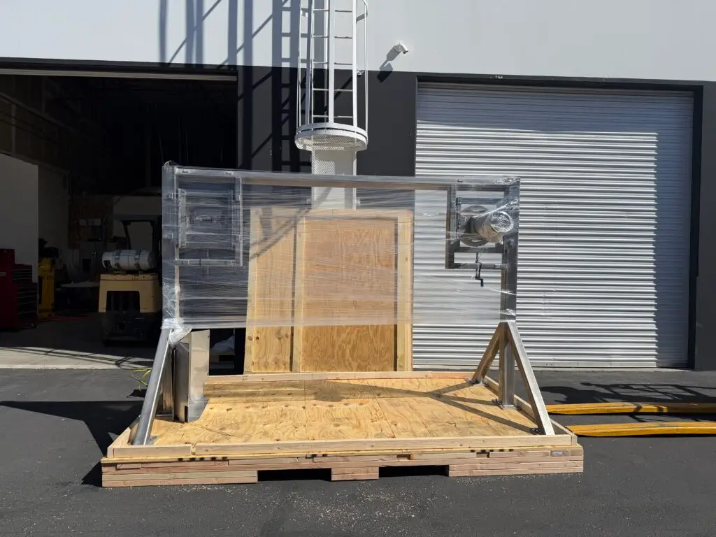 Custom shipping crate on pallet, protected with plastic wrap, crating services in the United States.