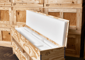 Custom wooden crate with foam interior protection, designed for safe storage and transport of valuable items, surrounded by additional wooden crates.